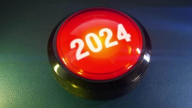 Pressing the big red button labeled with the message "2024"