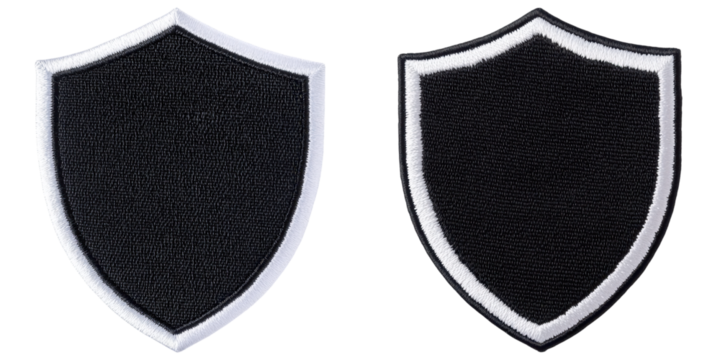 Two shield-shaped patches with black fabric, bordered by white edges, displaying a simple and bold design.