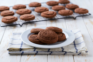 Chocolate brownie cookies on a white table, selective focus.
