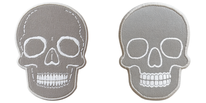 Two embroidered skull patches featuring distinct designs, showcasing details like eye sockets and teeth.
