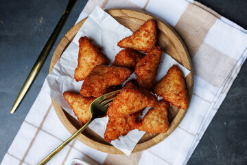 chicken nuggets with red sauce, ketchup, on a dark background with a white kitchen towel, fast food, snack
