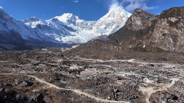 Manaslu, Nepal: Dramatic view of the Manaslu mountain peak on the way to the Pung Gyen Gompa day trip hike between Shyala and Sama along the Manaslu circuit trek on a sunny winter day in Nepal. 