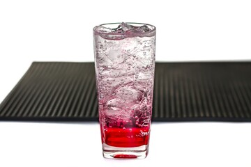 Sweet red ice soda served on cafe bar mat in white background and isolate concept.