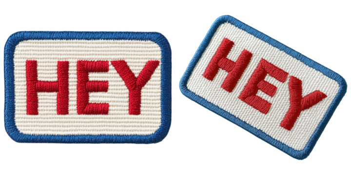 Two embroidered patches featuring the word "HEY" in bold red letters on a white background with blue borders.