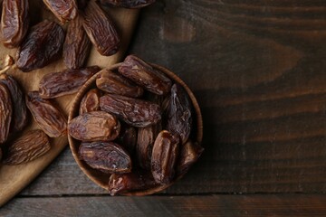 Tasty dried dates on wooden table, top view. Space for text