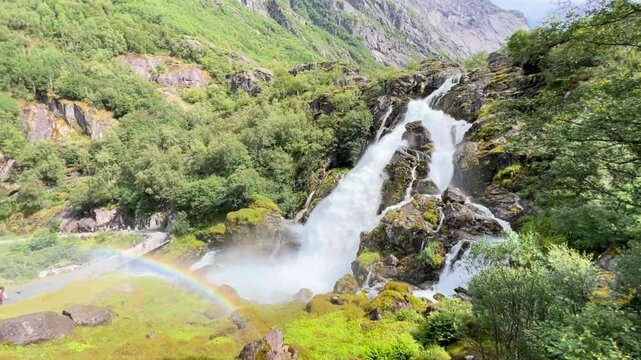 waterfall and rainbow in the mountains, Briksdalsbreen, Glacier in Norway
