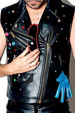 Man with customized black leather jacket against white background