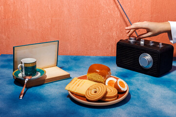 Woman turning retro radio kept on table near breakfast