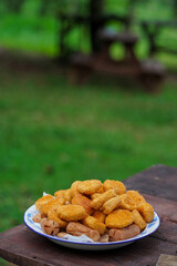 a plate full of nuggets on a picnic table, the concept of travel.