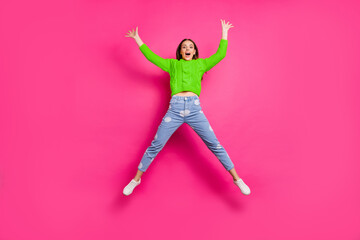 Full size photo of cute lady with her raised hands jumping wearing yellow sweater dotted denim...
