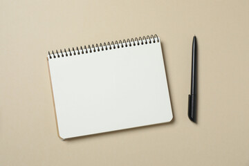 Top view photo of notebook with a pen on color background with blank space. Business concept