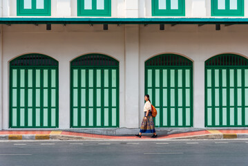 Woman tourist with Thai cloth walking near Sam Yot MRT subway station building in Bangkok Thailand.