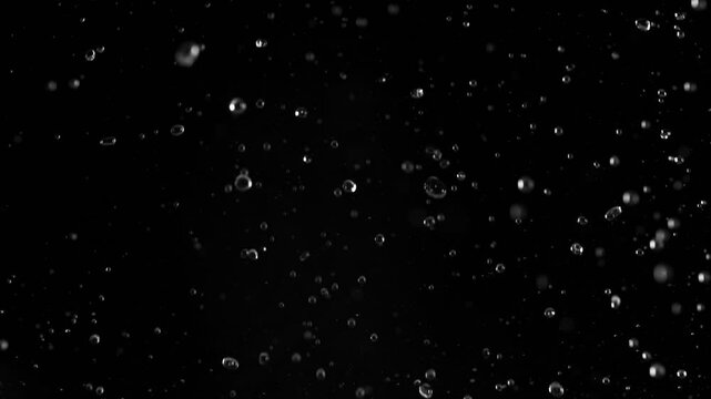 Super Slow Motion of Flying Water Drops, Isolated on Black Background. Filmed on High Speed Cinema Camera, 1000fps.