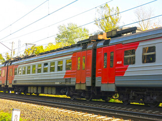 suburban train passes by a station near Moscow in the summer