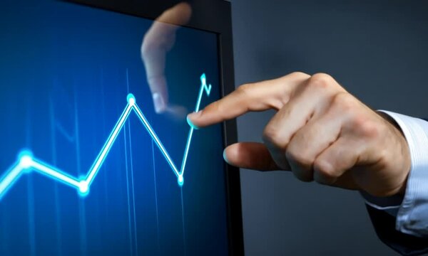 A hand interacts with a digital graph, indicating data trends and analysis.