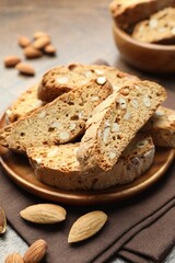 Traditional Italian almond biscuits (Cantucci) and nuts on table, closeup