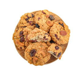 Delicious oatmeal cookies with dried cranberries and nuts isolated on white, top view