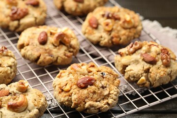 Tasty cookies with nuts on wooden table, closeup