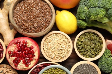 Different superfood products on wooden table, closeup