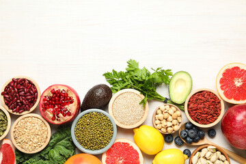 Different superfood products on white table, flat lay. Space for text