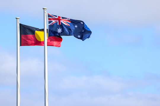 Cape Leeuwin, Western Australia, Australia - October 17 2024: National Australian and Aboriginal flags flying in the wind. Copy space.