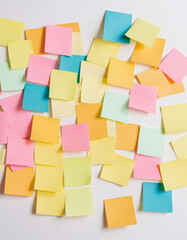 Colorful sticky notes arranged randomly on a white background, creating a vibrant and organized workspace aesthetic