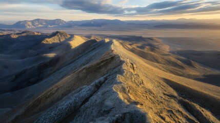 Breathtaking Aerial View of Mountain Peaks at Sunset: A Scenic Panorama of Rugged Terrain and Serene Wilderness in Golden Hour Light
