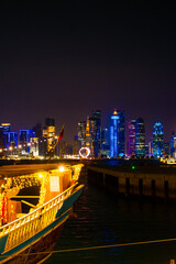 View of seaside tour boat and buildings in the corniche area of ​​Doha, Qatar