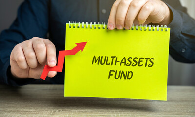 Multi-assets fund concept. Investment fund that allocates its portfolio across a diverse range of asset classes, such as stocks, bonds, real estate, and commodities. Notebook and arrow in male hands