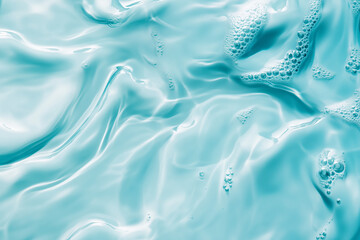 Obraz premium Blue Ripples and Transparent Water Surface with Splashes and Bubbles in Sunlight Reflection Perfect for Skincare and Cosmetic Backgrounds