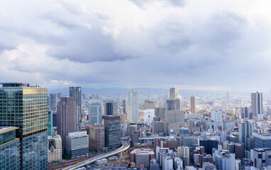 Cityscape of Osaka City in the evening from Umeda sky building tower, Osaka, Japan. Aerial view. In Cloudy day of autumn season.