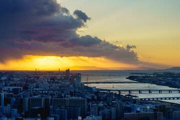 Cityscape of Osaka City and Yodo river in the evening from Umeda sky building tower, Osaka, Japan. Aerial view. Twilight sky with cloud and rainy in autumn season.