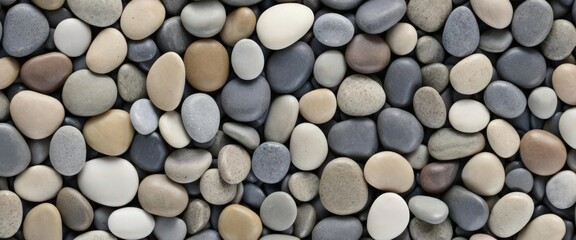 Smooth multicolored stones closely arranged on a flat surface.