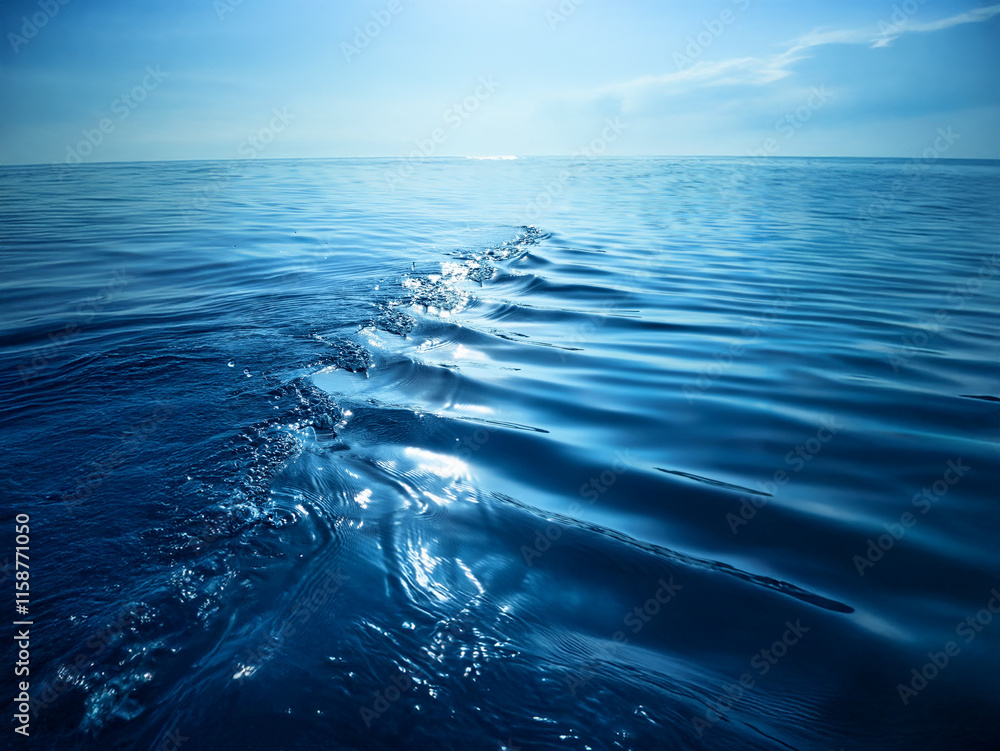 Aufkleber serene ocean scene. deep blue water stretches to the horizon, disturbed only by a gentle wake, sunli