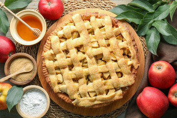 Flat lay composition with tasty homemade apple pie and ingredients on table