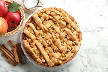 Homemade apple pie and ingredients on white marble table, flat lay