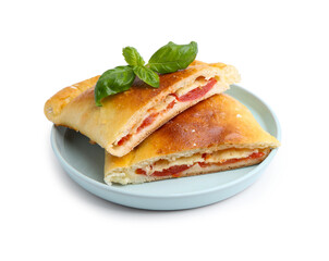 Pieces of tasty vegetarian calzone with tomato, cheese and basil isolated on white