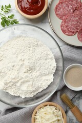 Making calzone pizza. Different ingredients on white marble table, flat lay