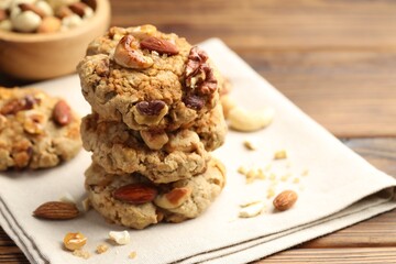 Tasty cookies with nuts on wooden table, closeup