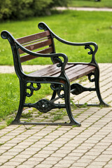 Beautiful old bench in a park town Sigulda. Made of wood and metal.