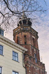City Hall Brick Tower in Kampen, The Netherlands, with the Nieuwe Toren behind it, against cloudy sky