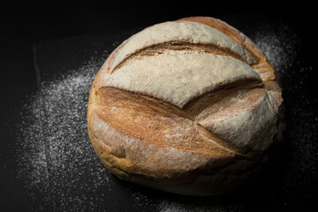 Freshly baked bread on a dark background. Fresh baked goods
