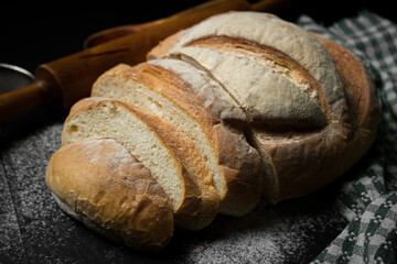 Freshly baked bread on a dark background. Fresh baked goods