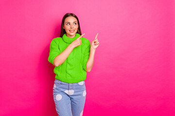 Portrait of nice lady showing adverts looking wearing yellow pullover isolated over fuchsia...