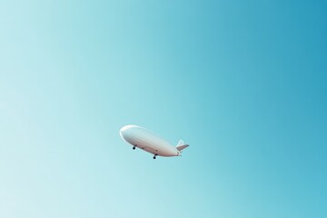Minimalist Aerial View of a White Blimp against Clear Blue Sky for Modern Design Use
