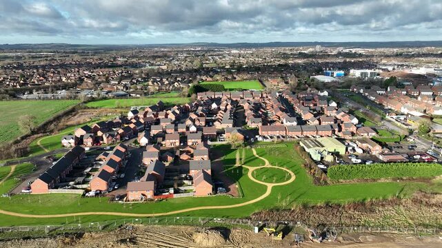 view of southern Aylesbury modern housing estate surrounded by green fields and sunshine in England