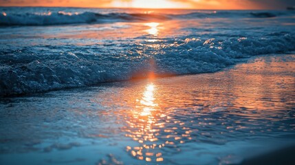 Fototapeta premium Sunset ocean wave reflecting light on beach.