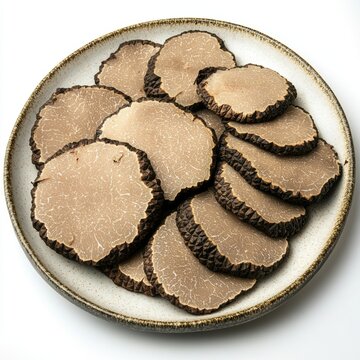 A plate of thinly sliced truffles, showcasing their unique texture and appearance.