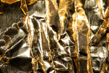 Jagged Crumpled and Creased Gold Shiny Metal Metallic Background