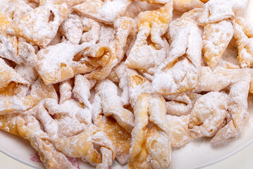 Angel wings (Faworki), cakes. Sweet pastry deep fried and sprinkled with powdered sugar